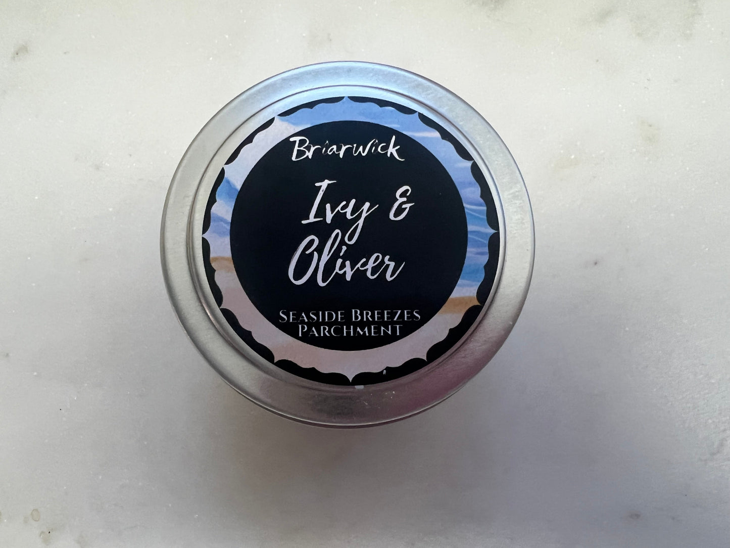 Tin with 'Ivy & Oliver' label on a light background